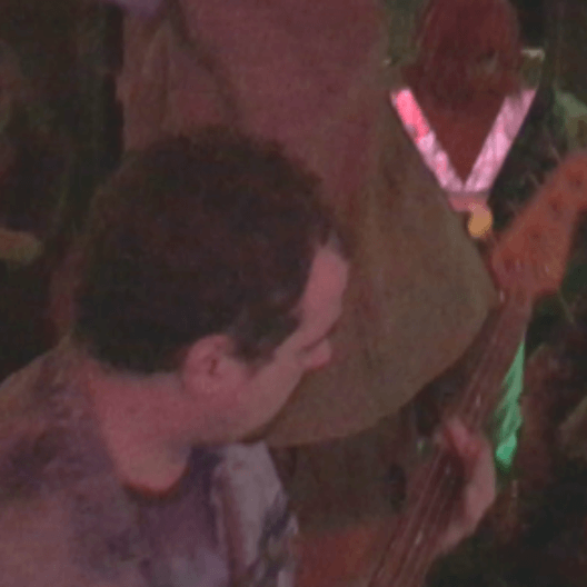 Oozerus playing bass within the mosh pit!